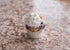 Small dessert cup with whipped cream on a marble surface